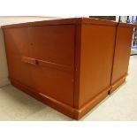 A pair of mid 20th Century oxide red painted two door livery style cabinets,