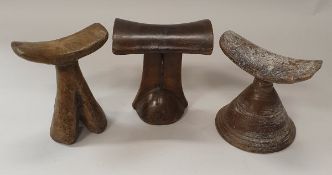 A collection of three African tribal carved wooden headrests