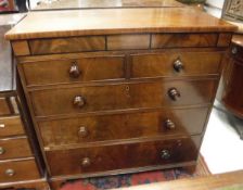 A Victorian mahogany chest with secret drawer enclosing three lidded compartments over two short