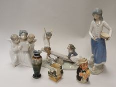 A Lladro figure of three singing angels, a Lladro of boy and girl on a seesaw,