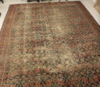 A Persian carpet the central panel set with all over floral decoration on a dark blue ground within