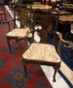A pair of 18th Century mahogany Irish elbow chairs the splat back with carved detail to shaped seat