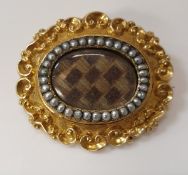A Victorian 18 carat gold mourning brooch with C scroll decoration to outside edge,