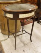 An Edwardian mahogany and satinwood strung oval bijouterie table on square tapered legs to splayed