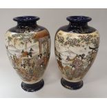 A pair of early 20th Century Japanese Satsuma vases decorated with panels of figures,