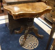 A Victorian walnut card table the serpentine front opening to reveal a baize lined interior on a