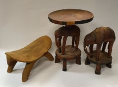 A Kenyan carved and painted wooden elephant figure and matching table with circular top together