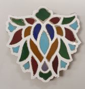 A 19th Century Turkish Moghul style tile of leaf form, decorated in various colours,