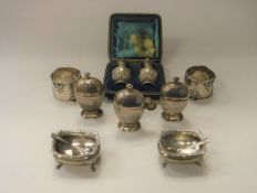 A collection of silver wares comprising an Edwardian silver three piece cruet in the Art Deco