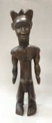 A Dan figure of a standing man with body decoration of geometric form together with a small Dan