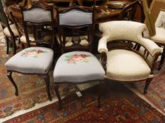 A circa 1900 rosewood framed upholstered open arm tub chair on turned legs to casters together with