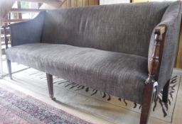 An early 19th Century upholstered three seat sofa with mahogany show frame and reeded arms on