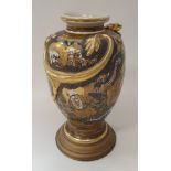 A Meiji period Japanese Satsuma ware vase with relief work dragon decoration on a dragon and