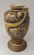 A Meiji period Japanese Satsuma ware vase with relief work dragon decoration on a dragon and