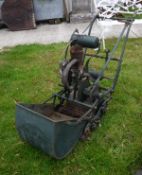An Atco petrol driven lawnmower, the metal framework stamped Chas Pugh Ltd,