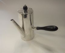 A George V silver coffee pot of plain tapered cylindrical form with ebonised handles (by Aitken