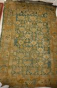 A Donegal style carpet the central panel set with all over floral decoration on a green ground