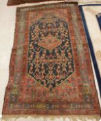 A Caucasian rug the central panel set with lozenge shaped medallion on a red floral decorated
