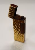 A gold plated Dunhill lighter with bark effect texture