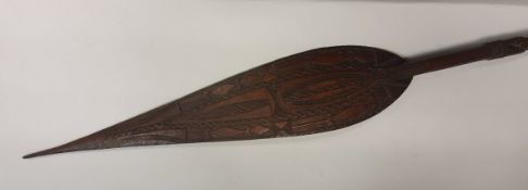 A pair of carved South Sea ceremonial paddles with carved decoration,