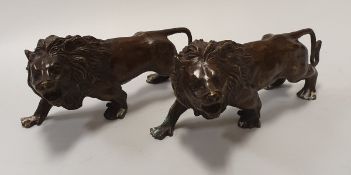 A pair of 20th Century bronzed male lion figures