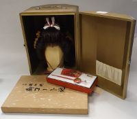 A Japanese Kabuki theatre wig with various adornments in a gold painted case together with two