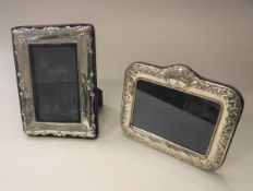 Two modern silver photo frames with embossed decoration,