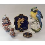 A Karl Ens macaw figure, two Meissen onion pattern leaf dishes,