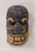 An Indian painted and carved wooden mask