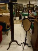 A 19th Century mahogany pole screen with fabric covered shield shaped panel,