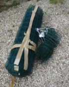 A roll of green plastic coated wire fencing and two rolls of edging of similar construction