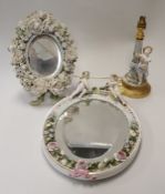 A Meissen style floral and cherub encrusted oval wall mirror bearing monogram "JR",