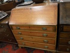 A 19th Century oak and mahogany cross banded bureau with sloping fall over four long drawers