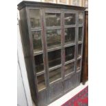 A painted cabinet, the glazed and barred front with two doors enclosing shelving,