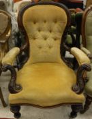 A Victorian walnut framed open arm salon chair with yellow buttoned upholstery,