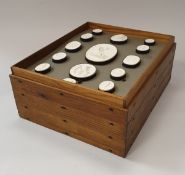 A collection of framed 19th Century plaster medallions housed in pine tiered box