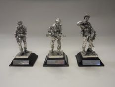 A collection of fourteen assorted silver plated models of World War II military figures on stands,