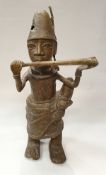 A Benin bronze figure of a horn player (or flute player) with feathered raffia work hat and ornate