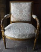 A 19th Century carved giltwood and gesso framed open armchair with upholstered back panel,