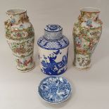 A pair of Chinese famille rose porcelain vases decorated with panels of figures and with dragon