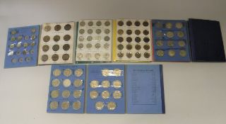 A collection of coins and collectors' wallets dating from 1900 onwards,