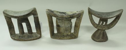 A collection of three African tribal carved wooden headrests