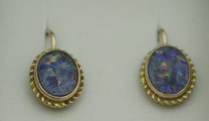 A pair of gold mounted opal set earrings