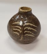 GEOFFREY WHITING (1919-1988) - a stoneware bottle with beaten sides and fern style decoration, 10.