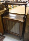 A Victorian walnut music cabinet with fretwork carved galleried shelf over a single glazed cabinet