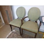 A composite set of twenty olive green upholstered spoon back chairs in the Georgian style (two on