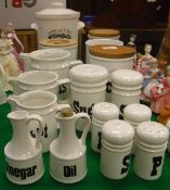 A collection of Arthur Wood black and white pottery storage jars and condiments including "Flour",