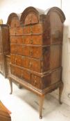 An 18th Century figured walnut veneered and feather banded chest on stand in three sections,