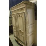 A modern carved and painted armoire in the Louis XV taste