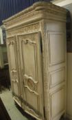 A modern carved and painted armoire in the Louis XV taste